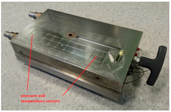 Injection mold with temperature and pressure sensors.