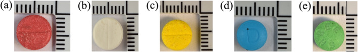 Examples of tablets seized from the Scottish prisons found positive for anabolic‐androgenic steroids (AASs): (a) FL23/0276‐1: 1× red tablet seized March 17, 2023, with oxymetholone and mestanolone; (b) FL22/0773: 1× white tablet seized July 18, 2022, with methyltestosterone and metandienone; (c) FL23/0203: 1× yellow tablet seized April 24, 2023, with oxandrolone; (d) FL23/0360: 1× blue tablet seized May 2, 2023, with oxymetholone and amitriptyline; and (e) FL23/0316: 1× green tablet seized May 15, 2023, with oxandrolone.